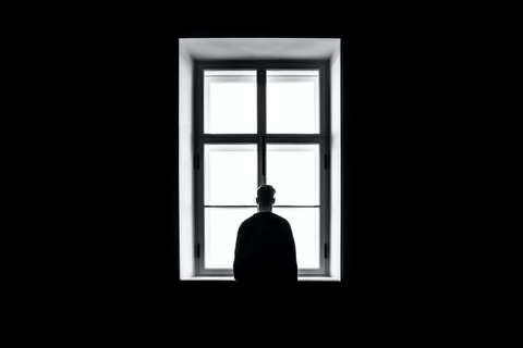 Silhouette of a person at a window