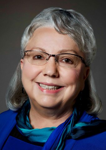 Gayle McLaughlin, a smiling white woman with gray hair and glasses.