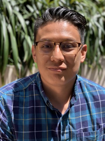 A Latino young man in glasses