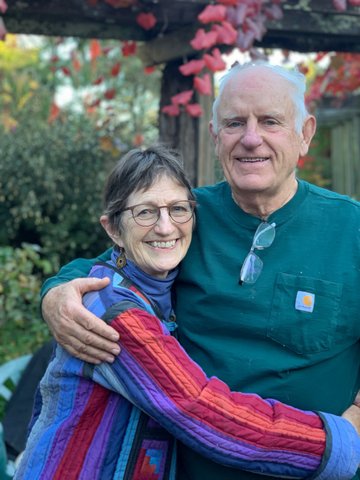 Smiling older man and woman standing in an embrace