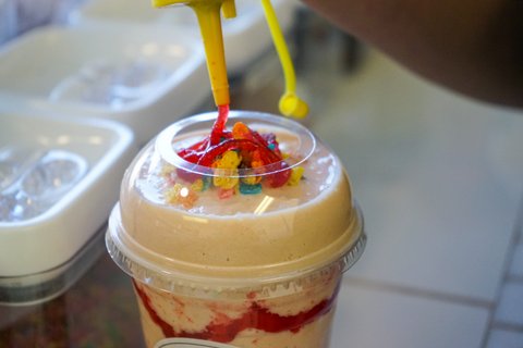 Close-up of shake topped with Fruity Pebbles cereal