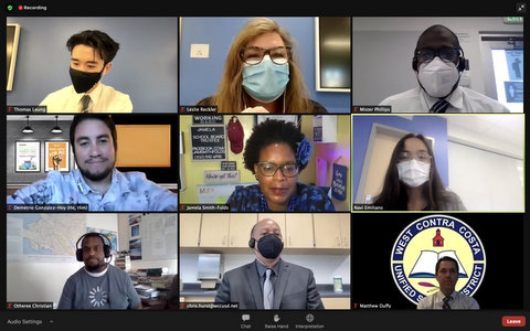 Nine people in a virtual meeting. Five are wearing protective masks.