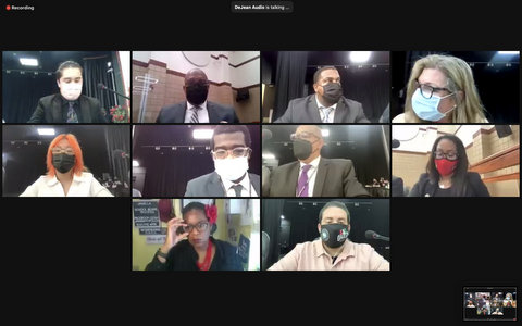 Ten people, nine wearing masks, in virtual meeting