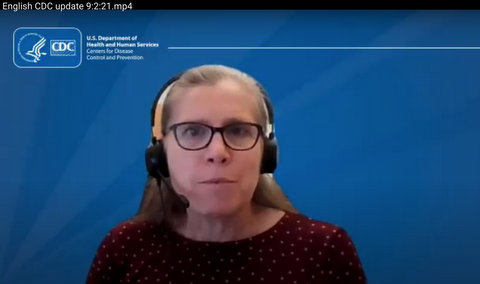 Woman with black-framed glasses and headset against blue background with CDC logo in the corner