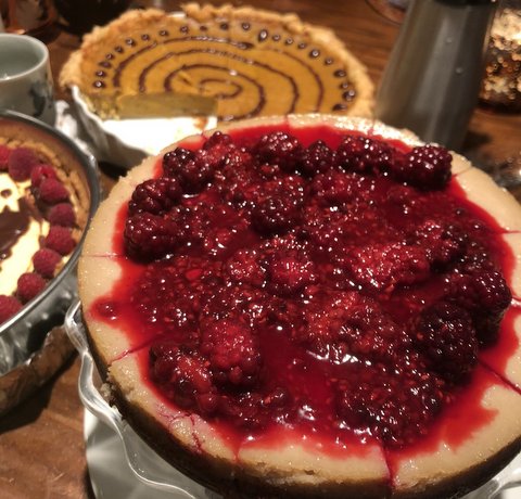 A berry cheesecake and a pumpkin pie