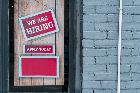 Signs that read "We Are Hiring" and "Apply Today"