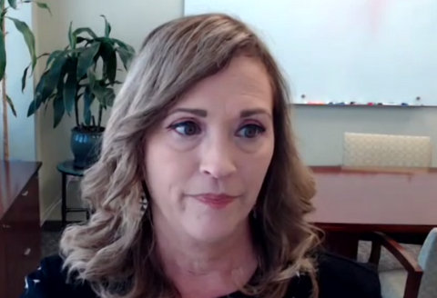 Head-and-shoulders shot of a white woman looking just offscreen