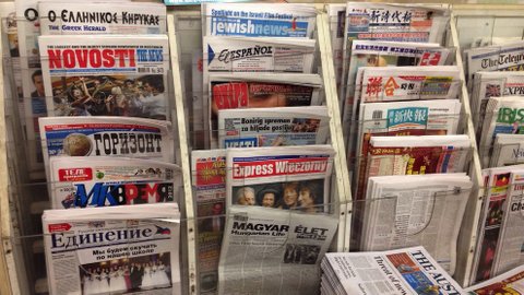 Rack of newspapers in different languages