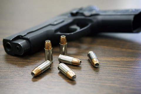 A black handgun and six bullets