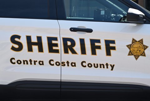 Close-up side view of a police vehicle with the words "sheriff contra costa county"