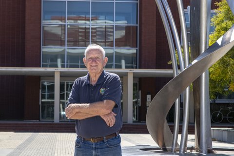 Older white man standing in front of building