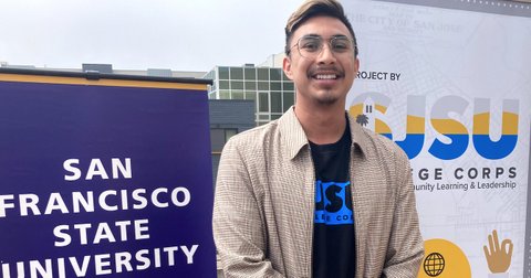Young Latino man wearing glasses between signs for San Francisco and San Jose state universities