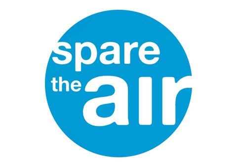 Blue circle inscribed with words "spare the air" in white