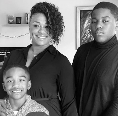 Black-and-white photo of a Black woman and her sons, aged 8 and 13.