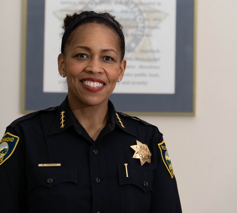 A Black and Latina woman in police uniform