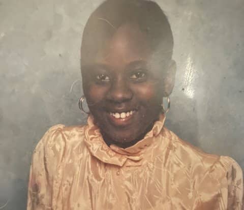 Head-and-shoulders shot of a smiling Black woman