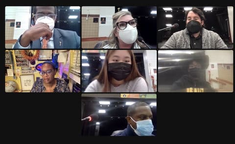 Seven people in virtual meeting. Six are wearing masks.