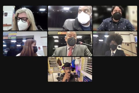 Seven people in virtual meeting. Six are wearing masks.