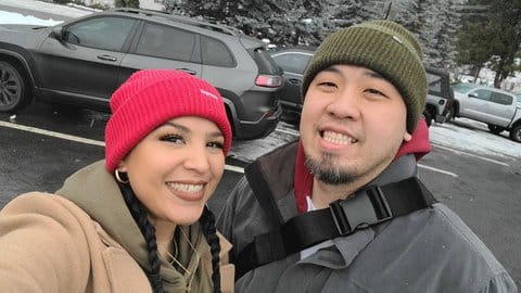 A Black and Latina woman and Asian man smiling in a selfie