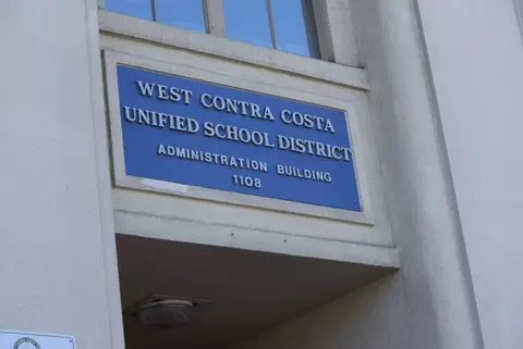 Sign on building that says West Contra Costa Unified School District Administration Building