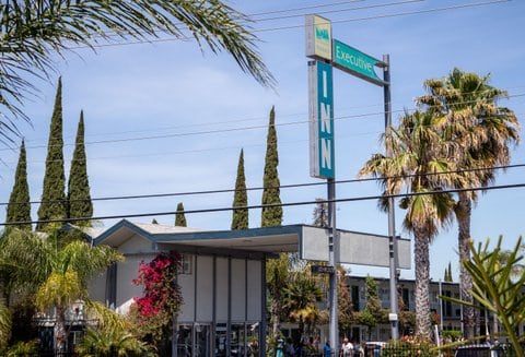 Exterior view of motel with large Executive Inn sign