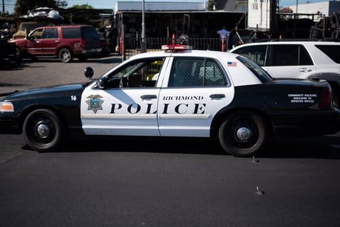 Black-and-white Crown Victoria police squad car that says Richmond Police