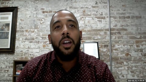 A Black man speaking on a webinar