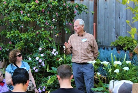 An older white man speaking at an outdoor event