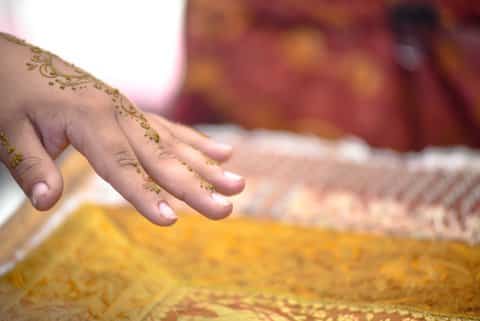 A person's hand adorned with a henna design