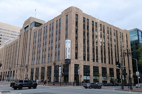 Street view of a large building with a sign that says Twitter