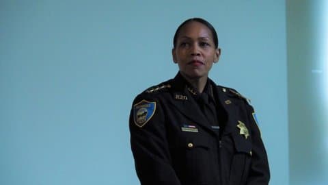 A Black woman in police uniform