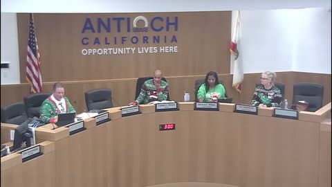A white man, Black man, Black woman and white woman, all members of the Antioch city council in a meeting and all wearing Christmas sweaters,